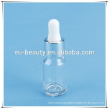 Cosmetic glass bottle with silver dropper cap